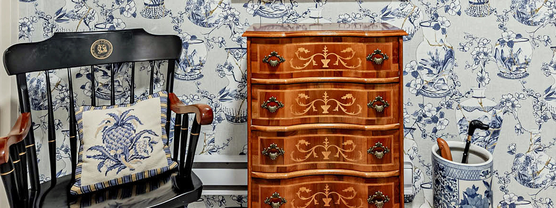 Chinoiserie Chalet: a Toronto mudroom in ginger jar wallpaper with built-in cabinetry and brass hardware
