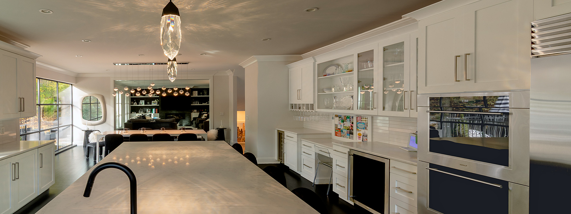 Crystal Cut Kitchen: an open-concept white kitchen with faceted jewel pendants by Schonbek
