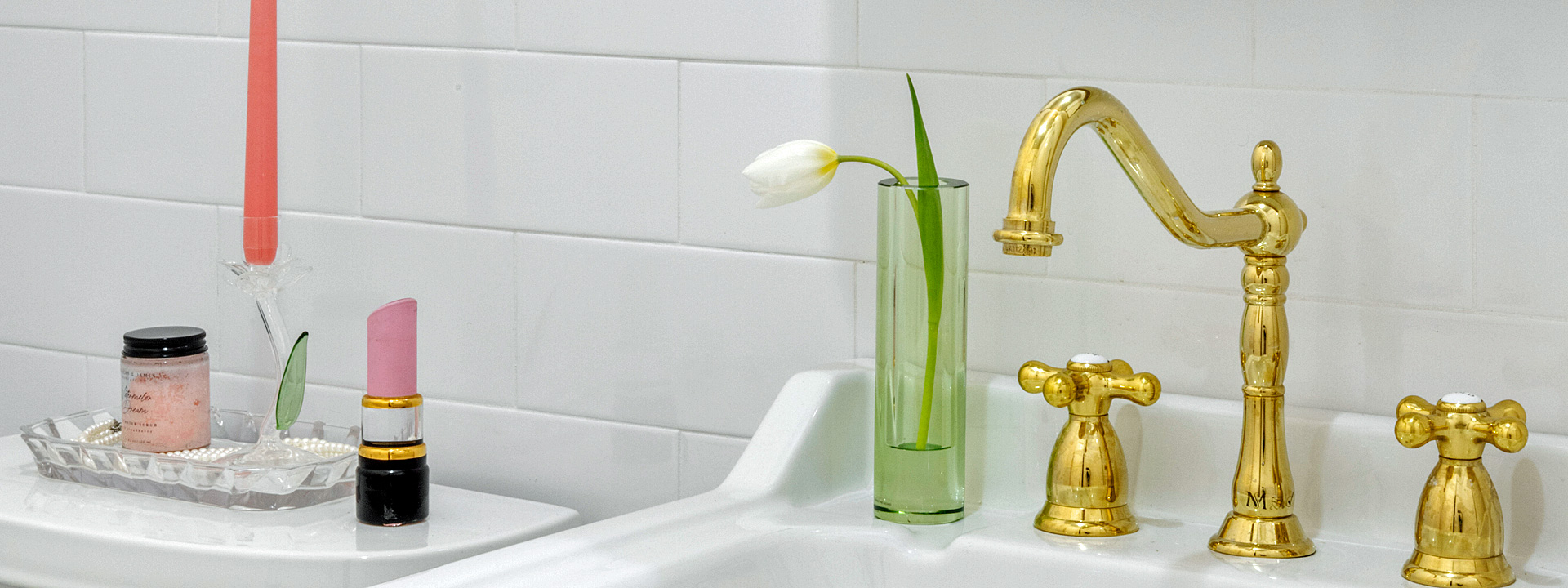 Pre-war Petal Powder: a Park Slope bathroom with a pedestal sink, brass fixtures and blooming hexagon floor tile