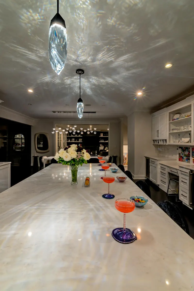 Crystal Cut Kitchen: a faceted crystal pendant above a white kitchen island